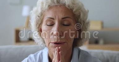 老年妇女在家<strong>满怀希望</strong>地祈祷，近距离观看
